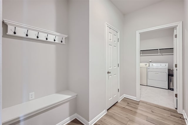 mudroom featuring light wood-type flooring and washing machine and dryer