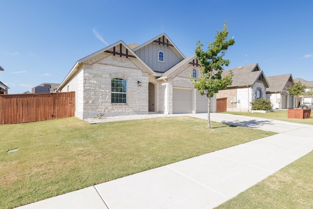 view of front of property with a front yard and a garage