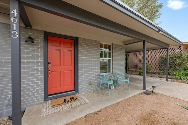 view of exterior entry featuring a porch