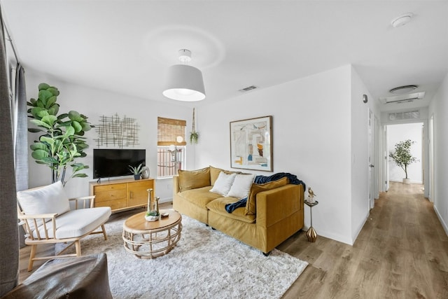 living room featuring a healthy amount of sunlight and wood-type flooring