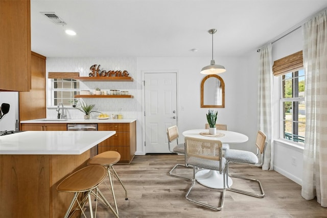 dining room with light hardwood / wood-style flooring and sink