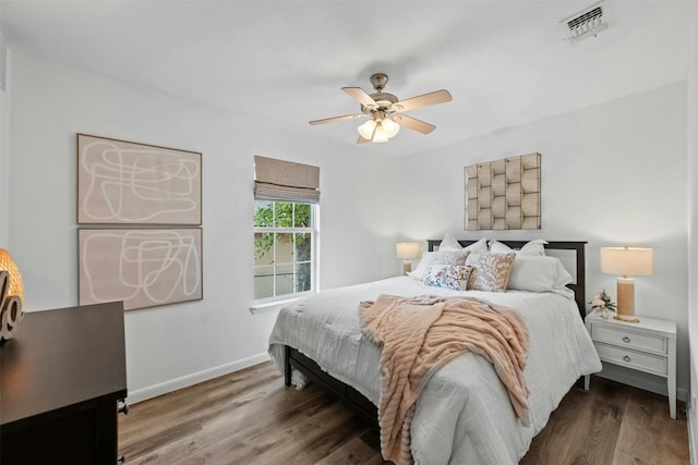 bedroom with dark hardwood / wood-style floors and ceiling fan