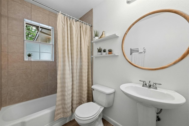 bathroom featuring shower / bathtub combination with curtain and toilet