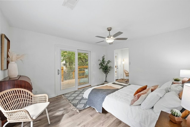 bedroom featuring access to exterior, ceiling fan, and light wood-type flooring