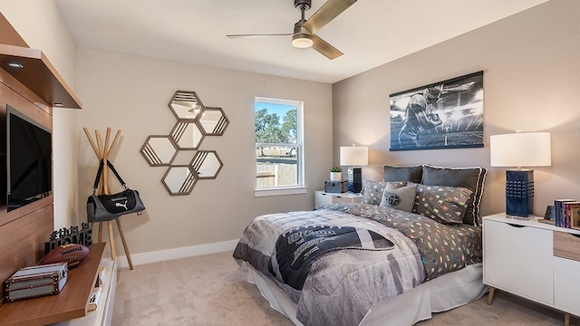 bedroom with ceiling fan and light carpet