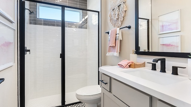 bathroom with vanity, an enclosed shower, and toilet