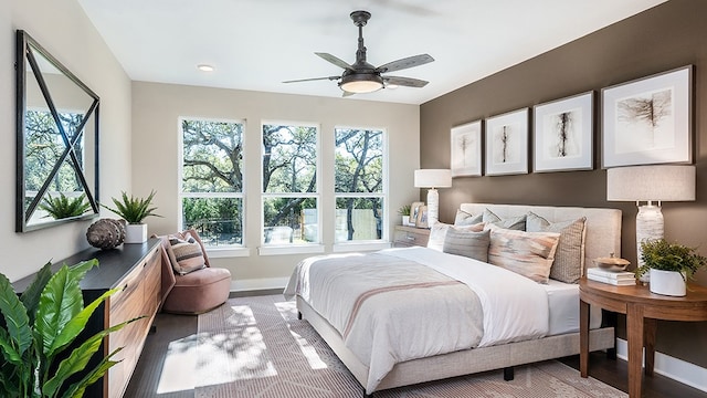 bedroom with ceiling fan and hardwood / wood-style floors