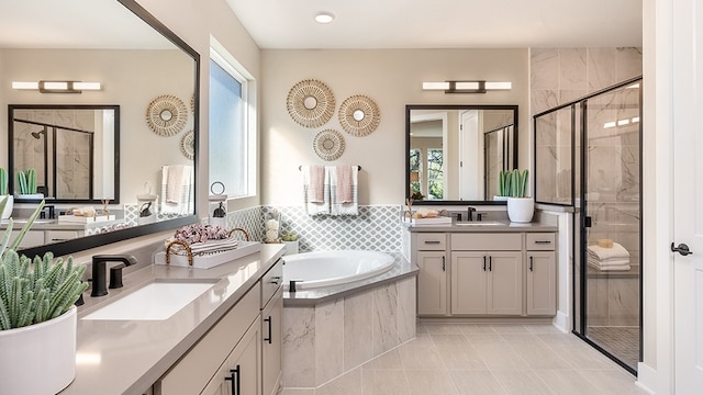 bathroom featuring vanity, plus walk in shower, and tile patterned flooring