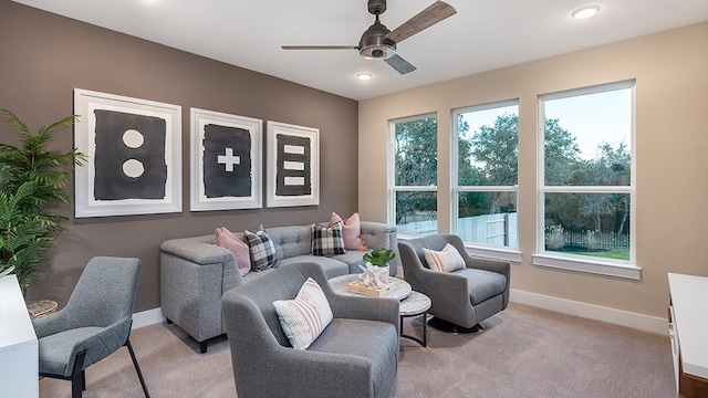 carpeted living room featuring ceiling fan