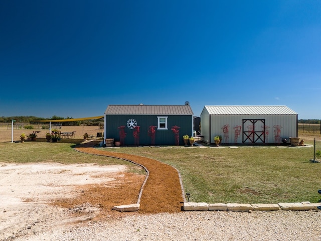 view of yard with a shed and a rural view