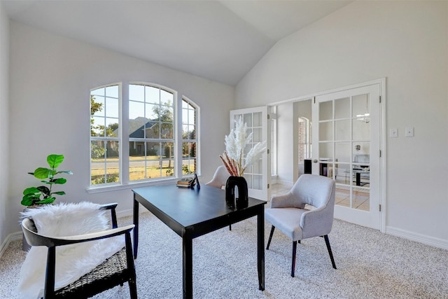 carpeted home office featuring french doors and vaulted ceiling