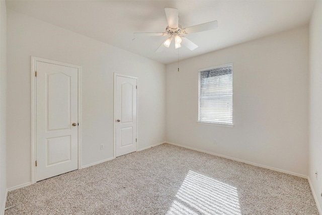 spare room with light carpet and ceiling fan