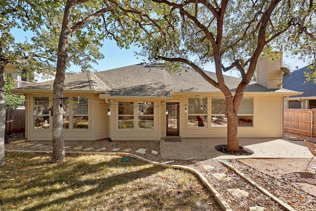 rear view of house featuring a patio and a lawn