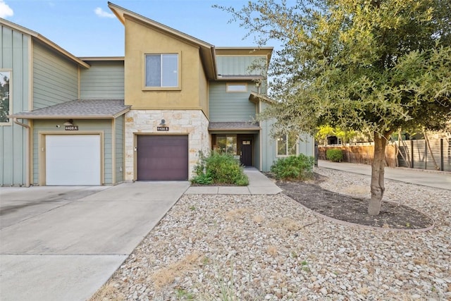 4408 Banister Ln Unit B, Austin, TX 78745 - view of property featuring an attached garage, driveway, stone siding, and fence