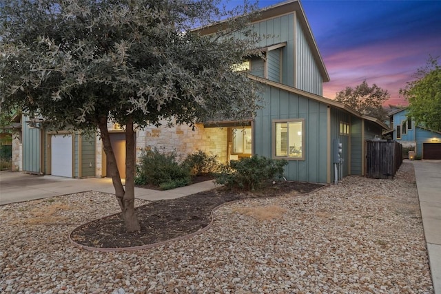 4408 Banister Ln Unit B, Austin, TX 78745 - view of front facade featuring driveway, fence, board and batten siding, and a garage