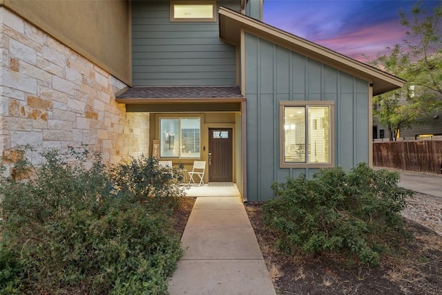 4408 Banister Ln Unit B, Austin, TX 78745 - doorway to property featuring board and batten siding, stone siding, and fence
