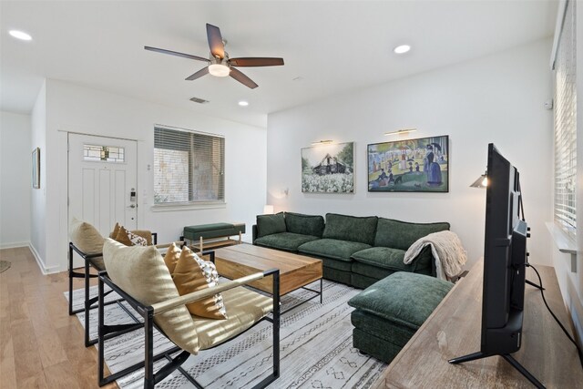 living room featuring light hardwood / wood-style floors and ceiling fan