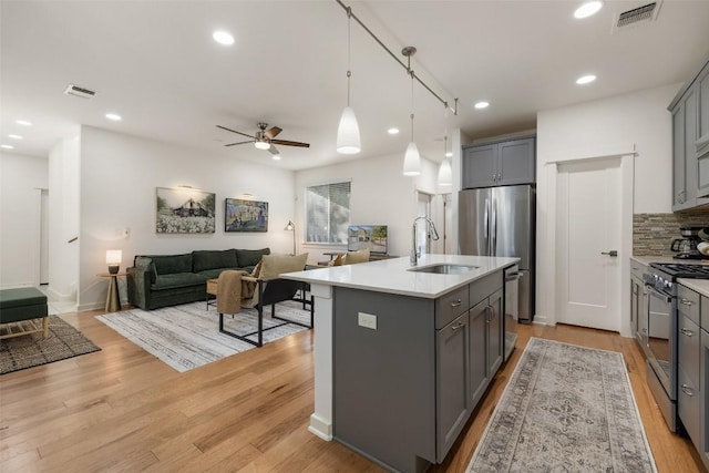 4408 Banister Ln Unit B, Austin, TX 78745 - kitchen featuring stainless steel appliances, gray cabinetry, and a sink