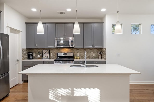 4408 Banister Ln Unit B, Austin, TX 78745 - kitchen featuring gray cabinetry, light wood-style flooring, stainless steel appliances, and a sink