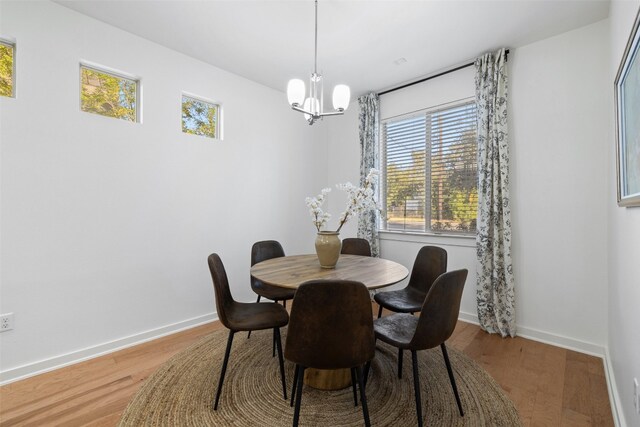 dining area featuring a chandelier, hardwood / wood-style flooring, and a healthy amount of sunlight