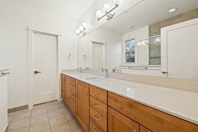 bathroom featuring vanity, a shower with shower door, and tile patterned flooring