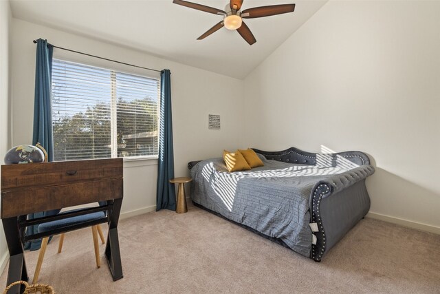 carpeted bedroom with ceiling fan and vaulted ceiling