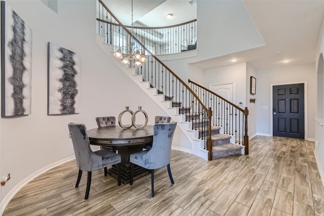 dining space featuring a chandelier and a high ceiling