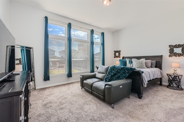 carpeted bedroom with multiple windows