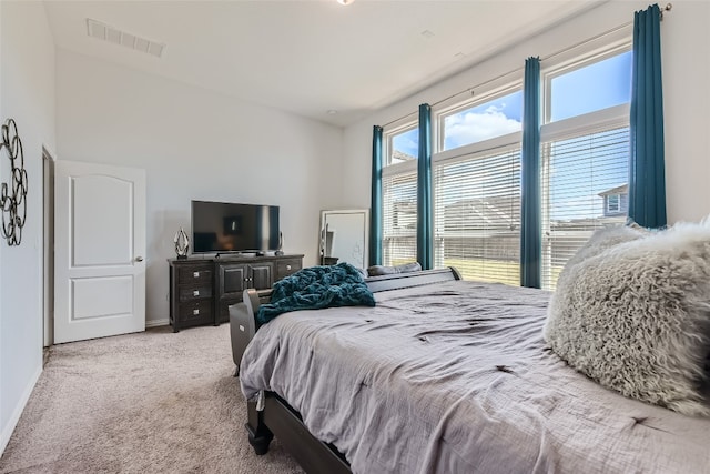 bedroom featuring light carpet