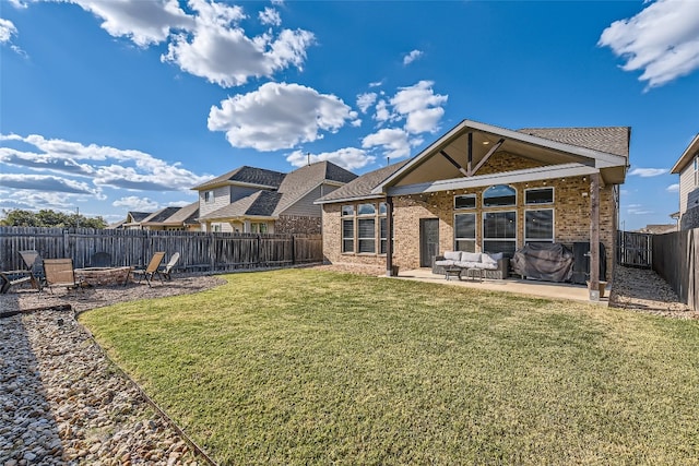 rear view of property featuring a yard and a patio