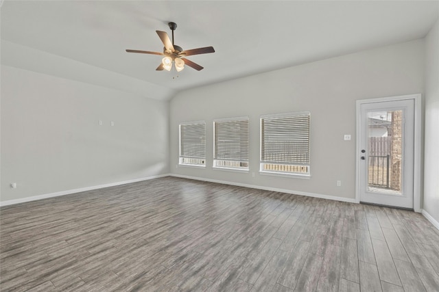 unfurnished living room featuring lofted ceiling, hardwood / wood-style floors, ceiling fan, and a wealth of natural light