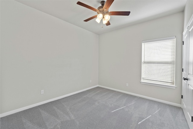 unfurnished room featuring ceiling fan and carpet floors