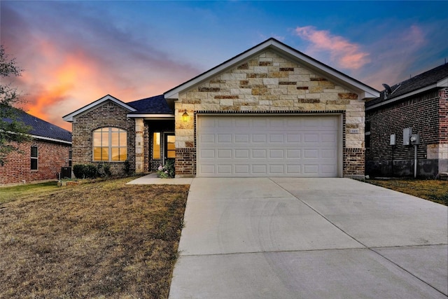 view of front of house featuring a lawn and a garage