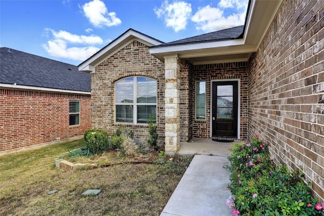 doorway to property with a lawn