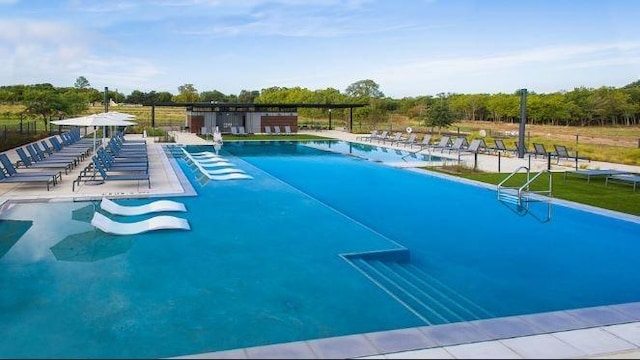 pool featuring fence and a patio area