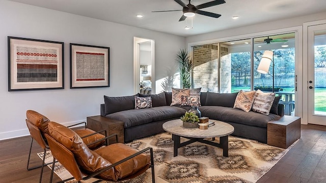 living room with wood-type flooring, a ceiling fan, baseboards, and recessed lighting