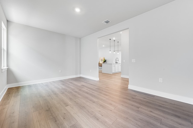 9213 Flatbush Dr, Austin, TX 78744 - spare room featuring light wood-style floors, baseboards, and recessed lighting