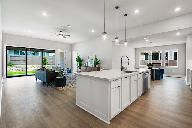 9213 Flatbush Dr, Austin, TX 78744 - kitchen with a sink, a kitchen island with sink, stainless steel dishwasher, open floor plan, and ceiling fan