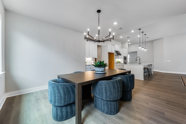 9213 Flatbush Dr, Austin, TX 78744 - dining space featuring a chandelier, wood finished floors, recessed lighting, and baseboards