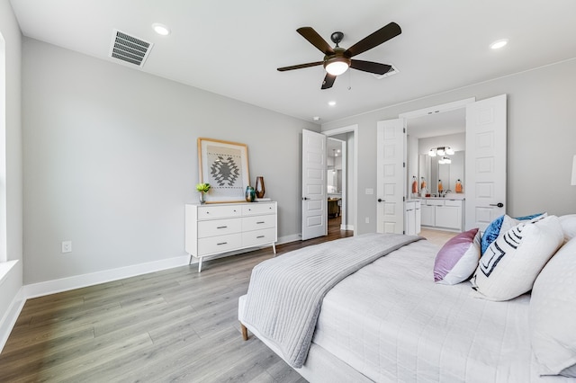 9213 Flatbush Dr, Austin, TX 78744 - bedroom with light wood-style flooring, ensuite bathroom, recessed lighting, baseboards, and a ceiling fan
