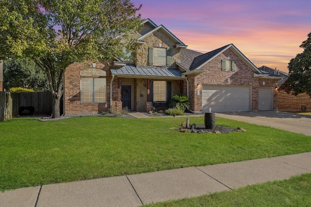 view of front of property with a yard and a garage