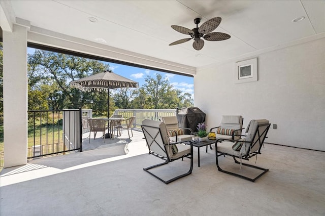 view of patio with area for grilling and ceiling fan