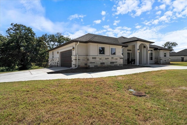 view of front of property featuring a garage and a front lawn