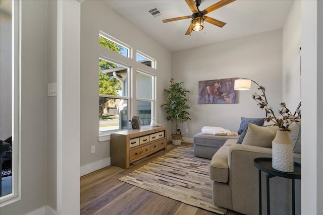 sitting room featuring light hardwood / wood-style floors and ceiling fan