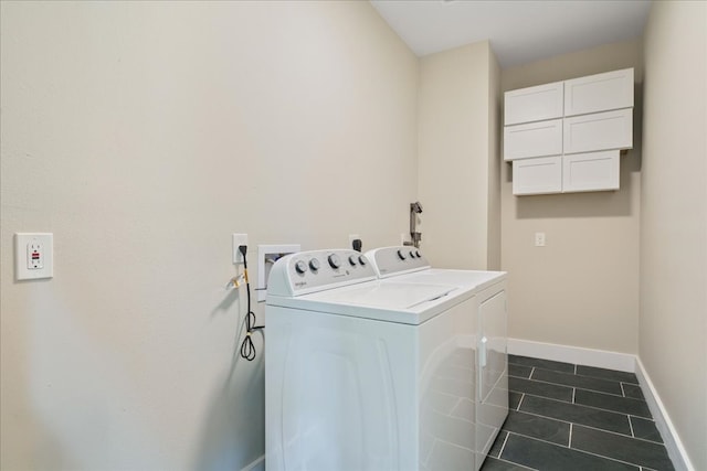 laundry area featuring dark tile patterned floors and washing machine and clothes dryer