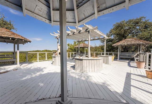 wooden terrace featuring a gazebo and a pergola