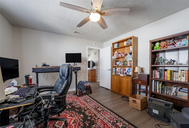 office space with ceiling fan, hardwood / wood-style flooring, and a textured ceiling