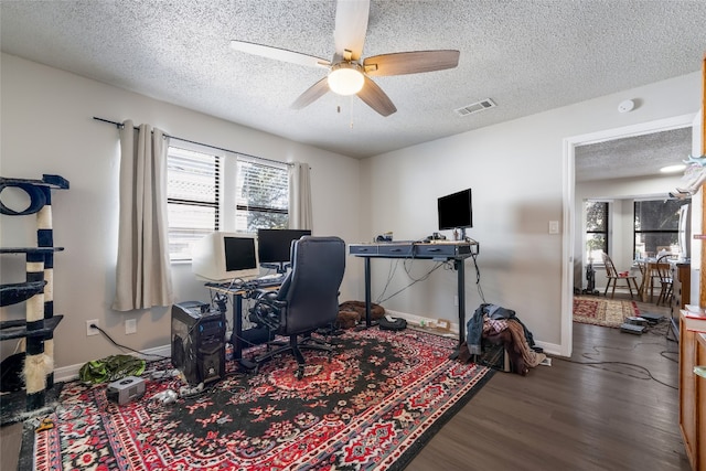 office area with a textured ceiling, wood-type flooring, and ceiling fan