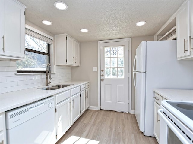 21401 Patton Ave Unit A & B, Lago Vista, TX 78645 - kitchen featuring white appliances, a sink, white cabinetry, light countertops, and a textured ceiling