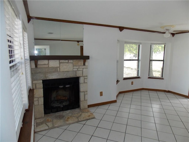21401 Patton Ave Unit A & B, Lago Vista, TX 78645 - unfurnished living room featuring a stone fireplace, baseboards, a ceiling fan, and light tile patterned flooring
